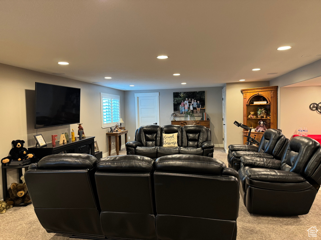 Carpeted living area with recessed lighting