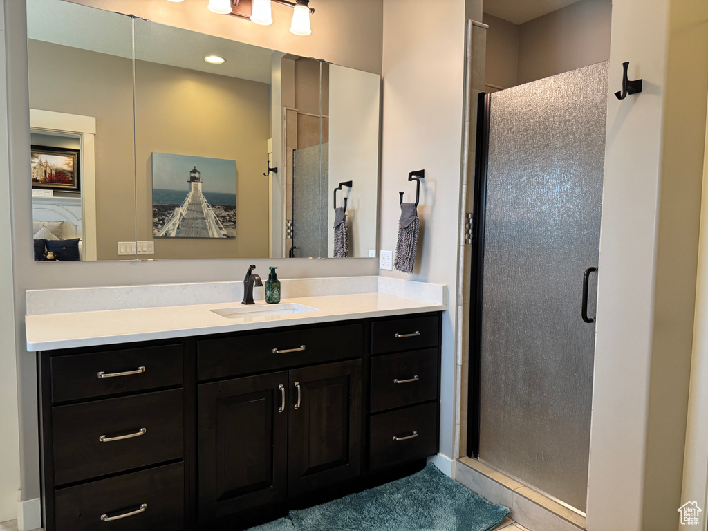 Bathroom with vanity and a shower stall
