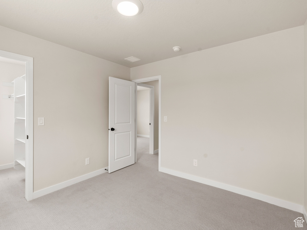 Unfurnished room with light carpet