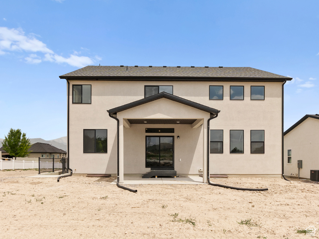 Rear view of house with a patio and stucco siding