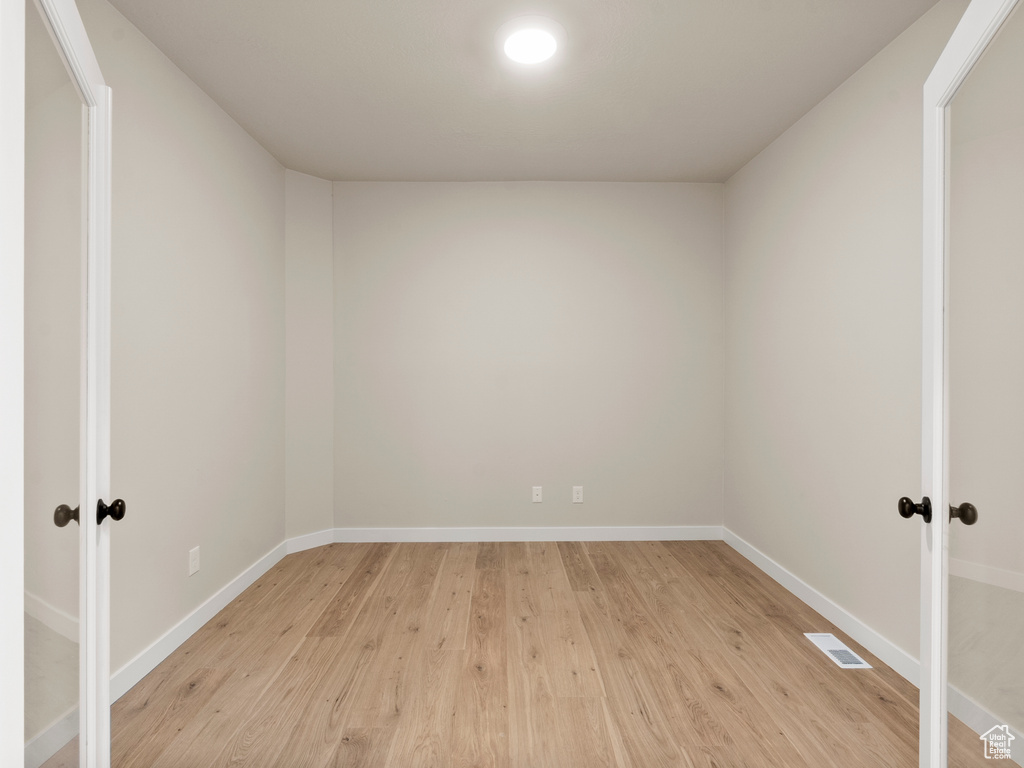 Spare room with french doors and light wood-style floors
