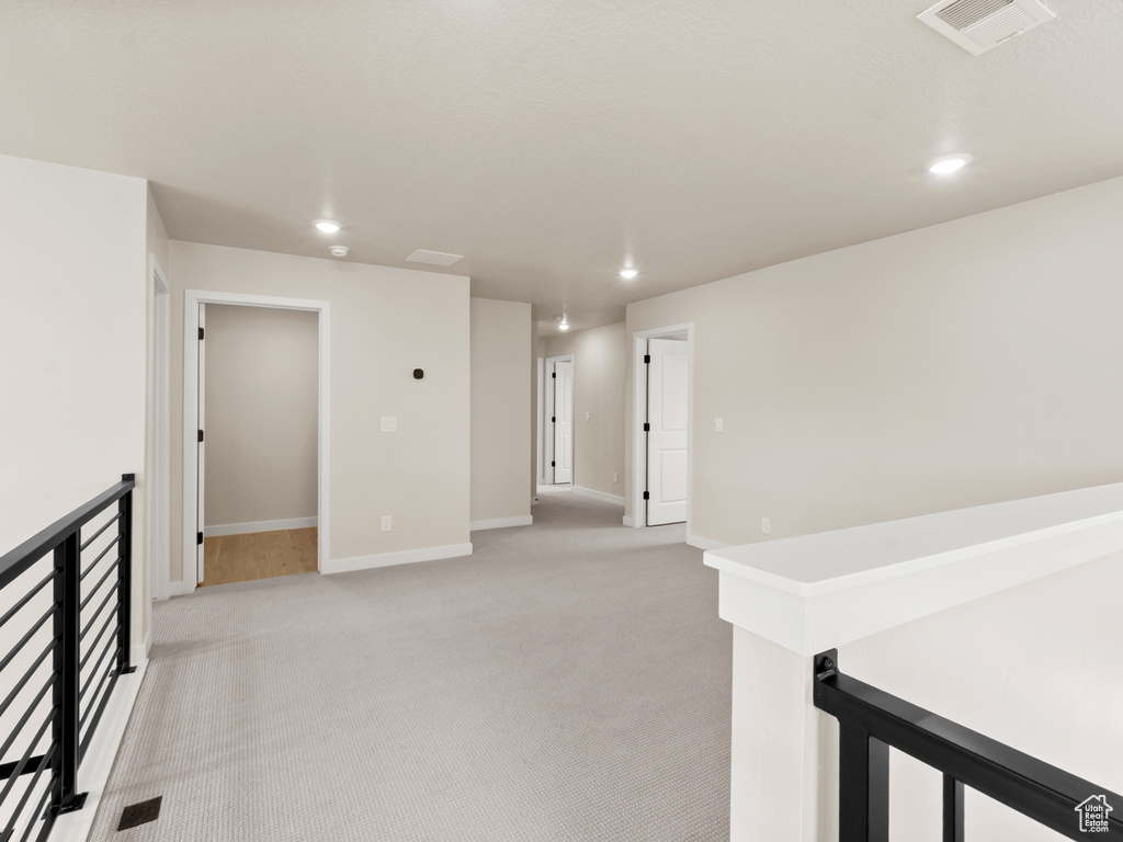 Unfurnished room with recessed lighting and light colored carpet