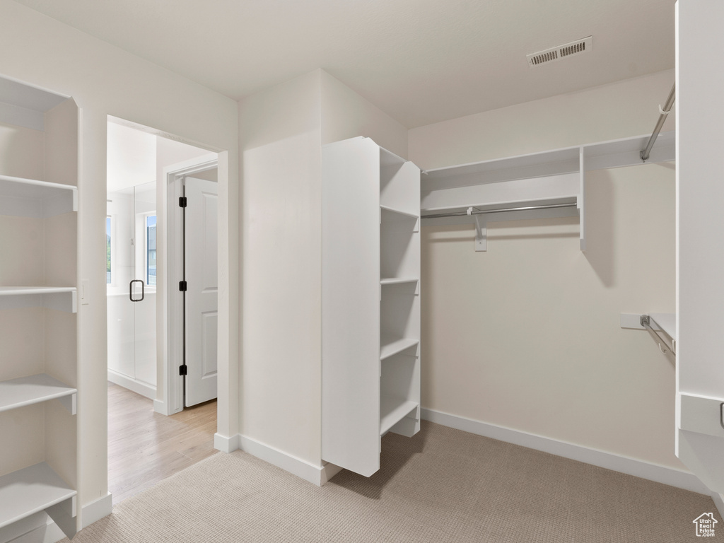 Spacious closet with carpet floors