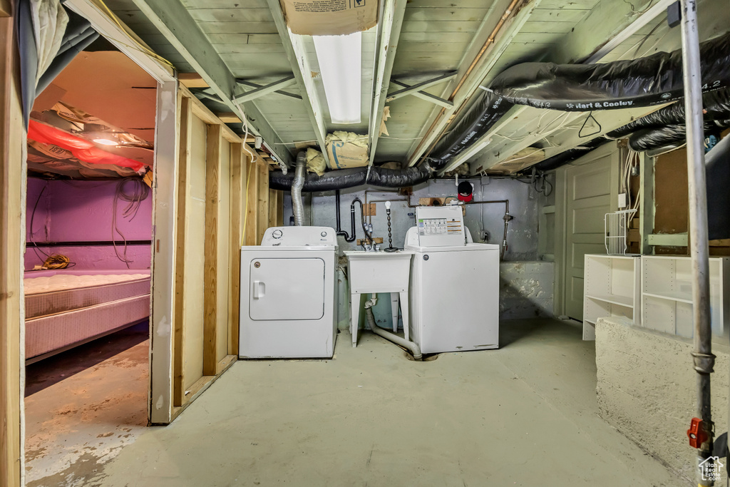 Unfinished below grade area with independent washer and dryer and a sink