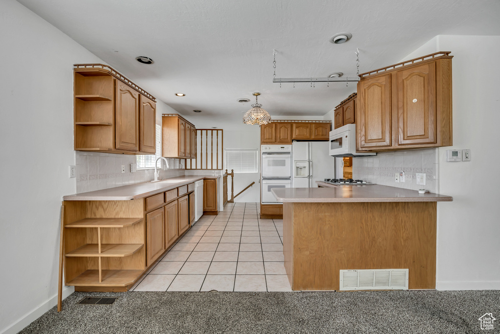 Kitchen with open shelves, white appliances, a peninsula, tasteful backsplash, and baseboards