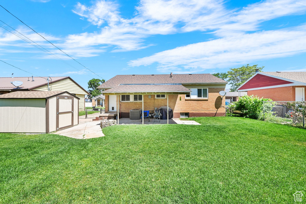 Back of property featuring a patio, brick siding, and central air condition unit