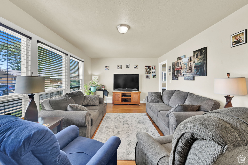 Living room with light wood-style flooring