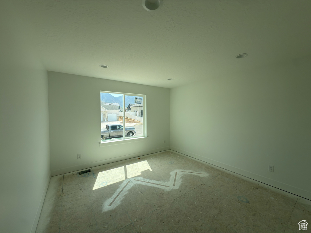 Spare room featuring baseboards