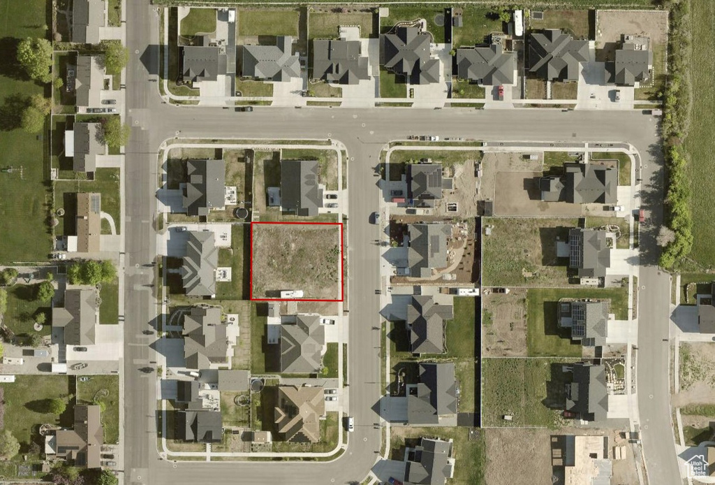 Aerial perspective of suburban area featuring property boundaries highlighted