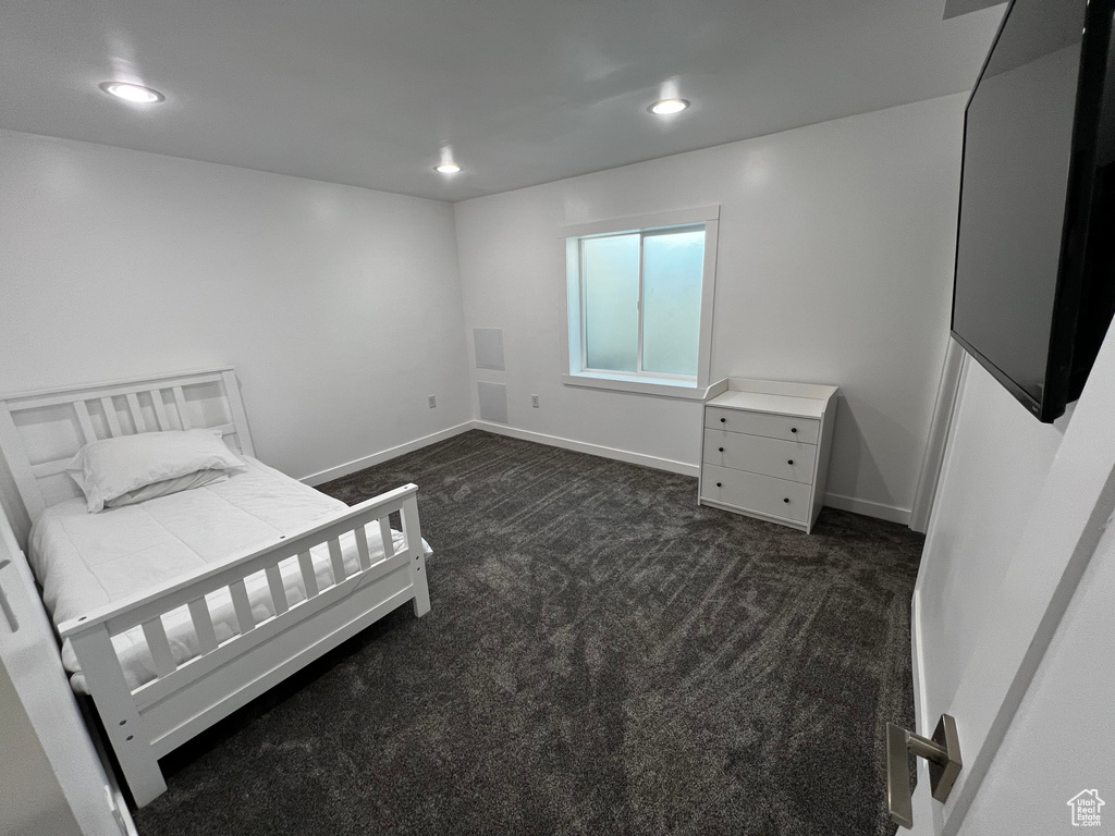 Bedroom featuring dark colored carpet, recessed lighting, and baseboards