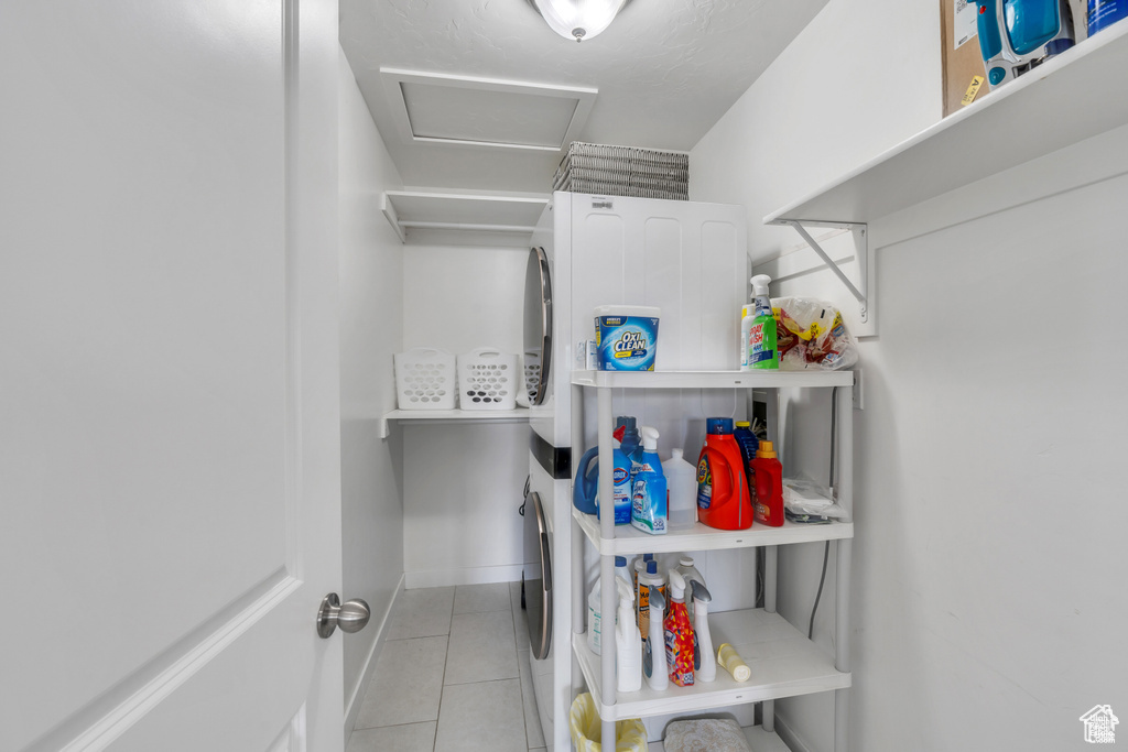 Laundry room with tile patterned flooring, attic access, and washer and dryer