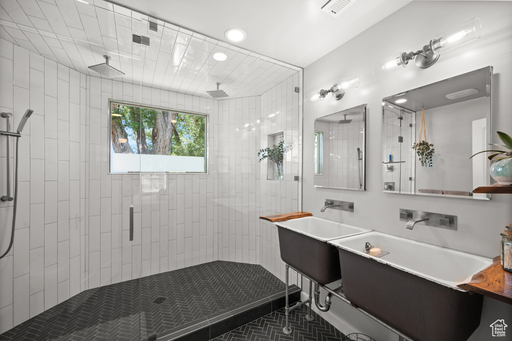 Full bathroom featuring a stall shower, tile patterned flooring, and vanity
