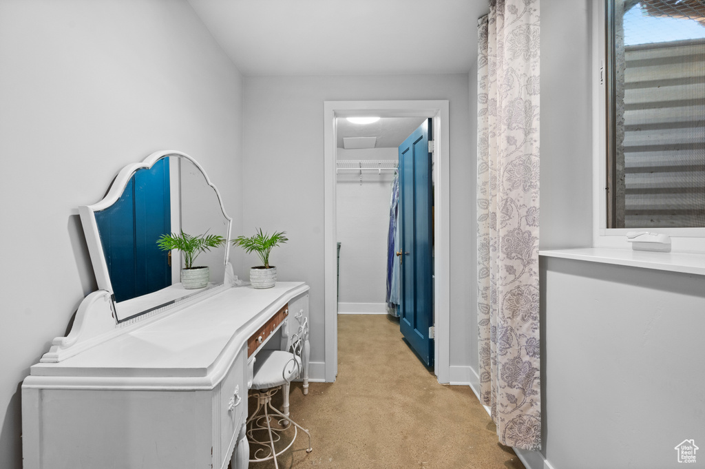 Home office featuring light carpet and baseboards