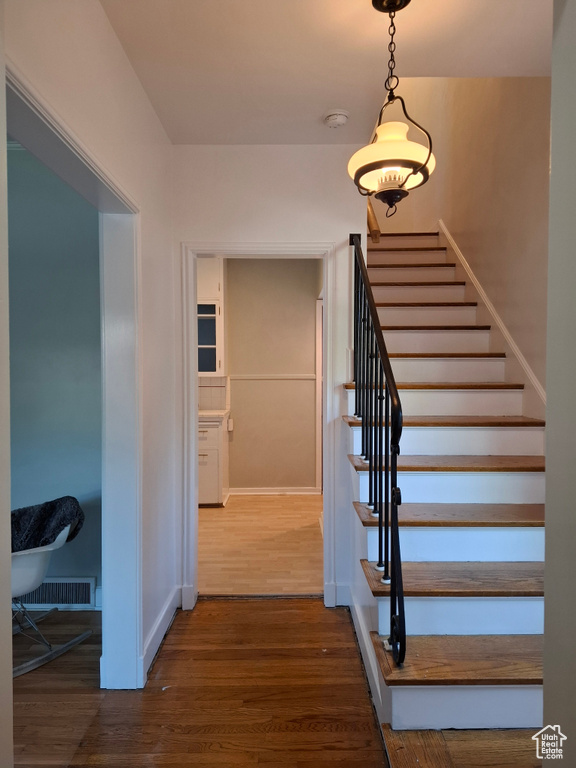 Staircase featuring wood finished floors