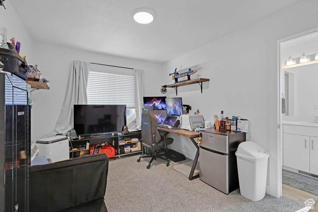 Office space with a sink and carpet flooring