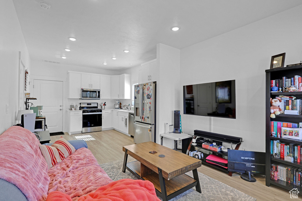 Living room featuring light wood-style flooring and recessed lighting