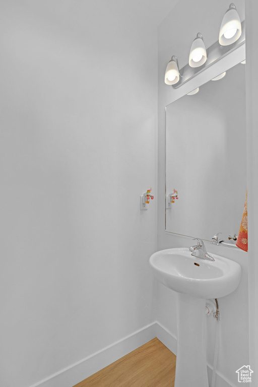 Bathroom featuring baseboards and wood finished floors