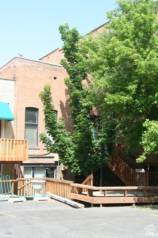 Back of house featuring brick siding and stairs