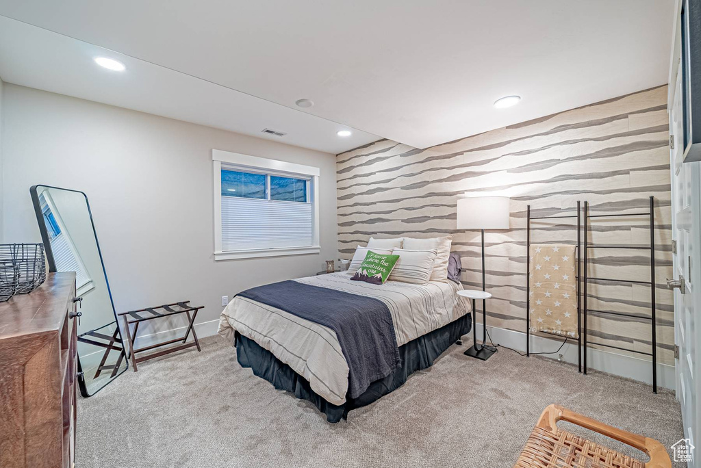 Bedroom featuring an accent wall, wallpapered walls, carpet flooring, baseboards, and recessed lighting
