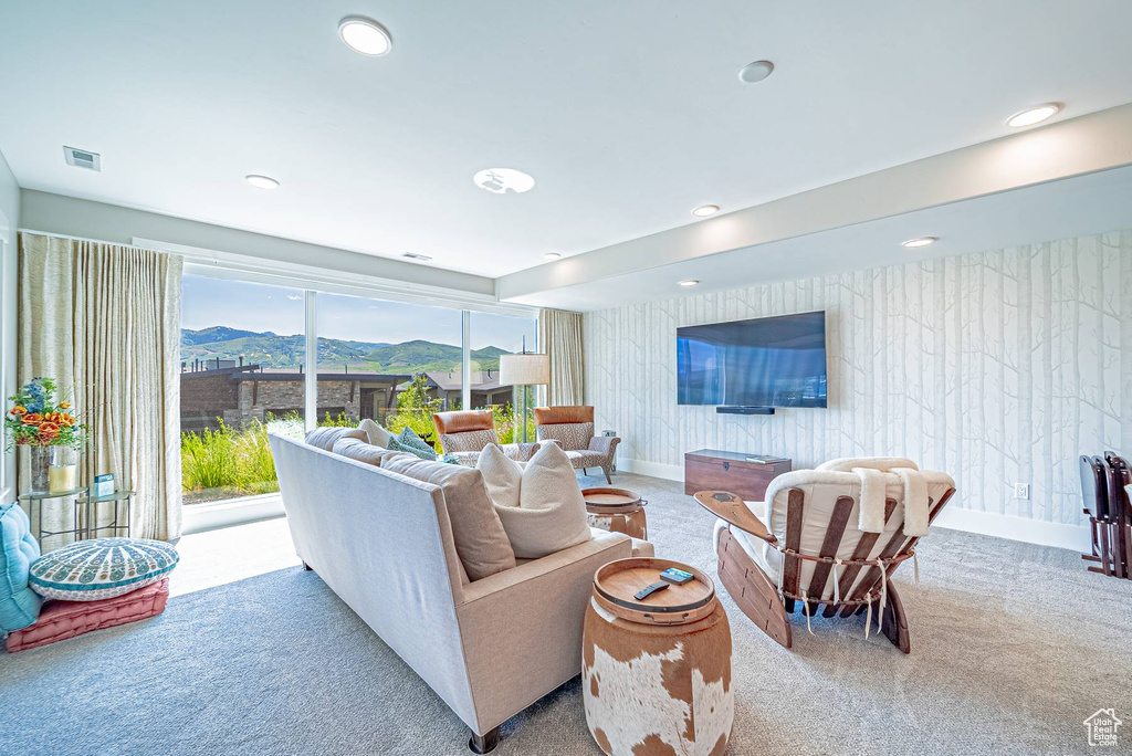 Carpeted living area featuring recessed lighting and baseboards