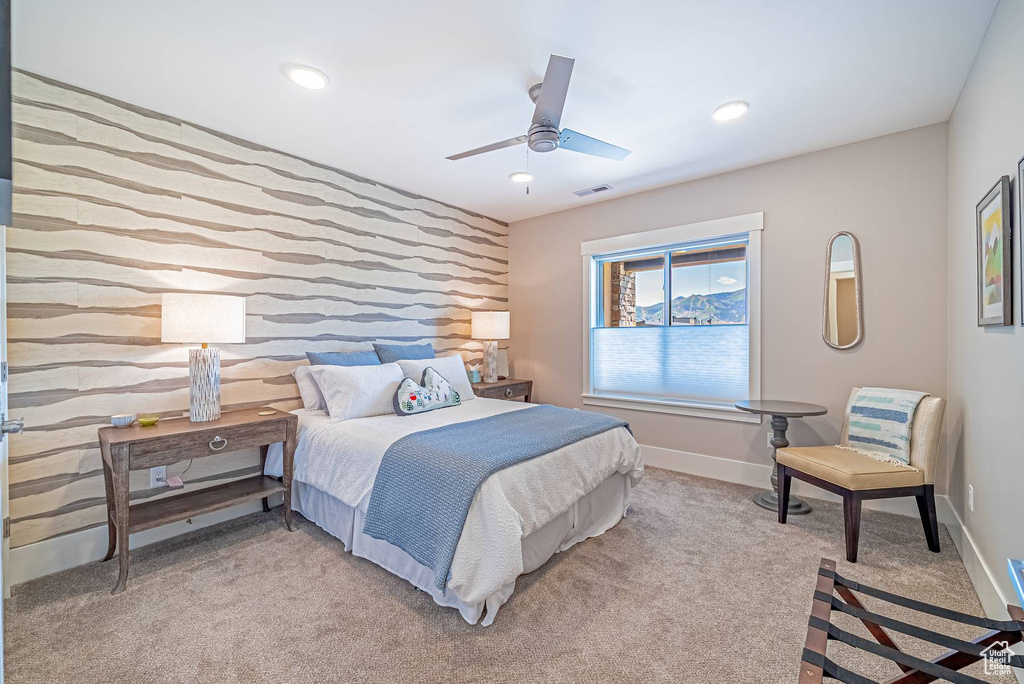 Bedroom featuring an accent wall, light carpet, baseboards, a ceiling fan, and recessed lighting