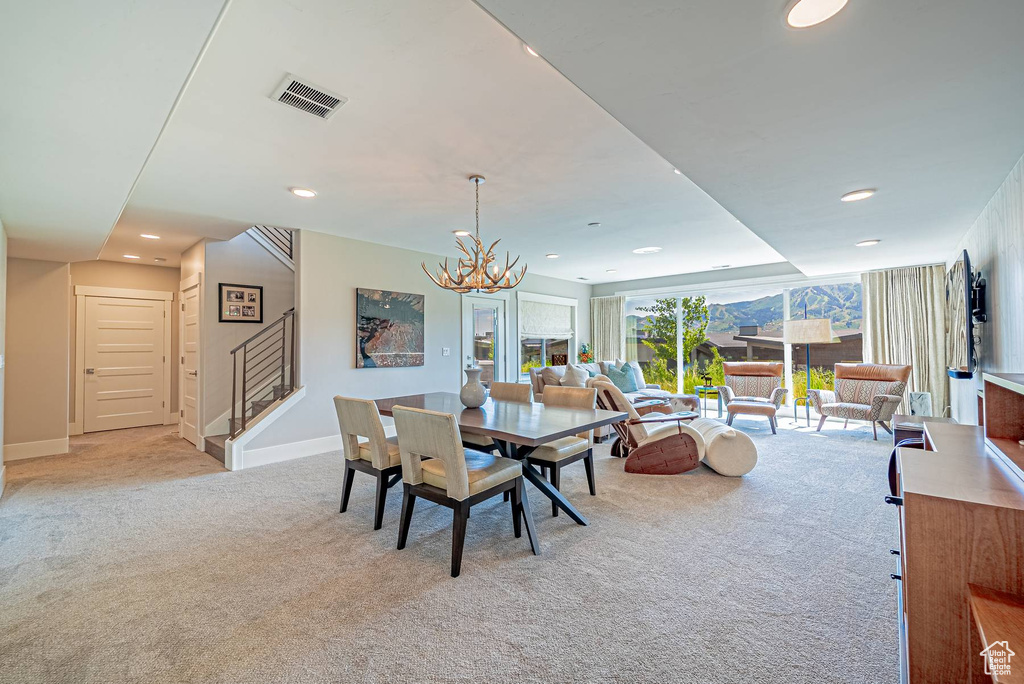 Dining area featuring light carpet, stairs, a chandelier, recessed lighting, and baseboards