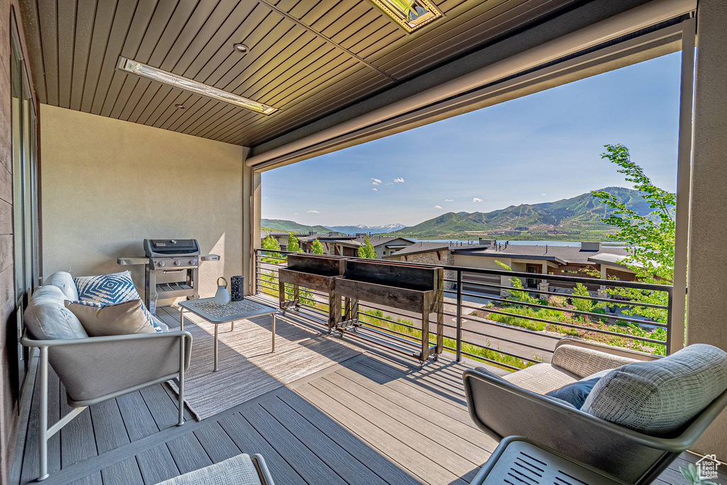 Wooden deck with a mountain view and grilling area