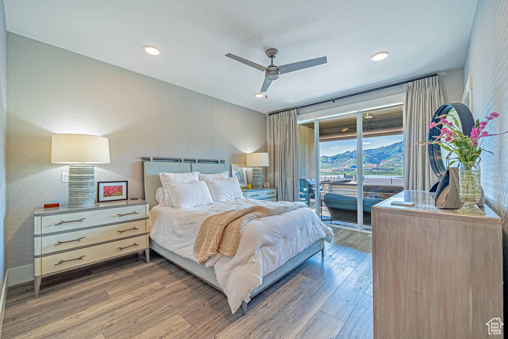 Bedroom featuring access to outside, wood finished floors, ceiling fan, wallpapered walls, and baseboards