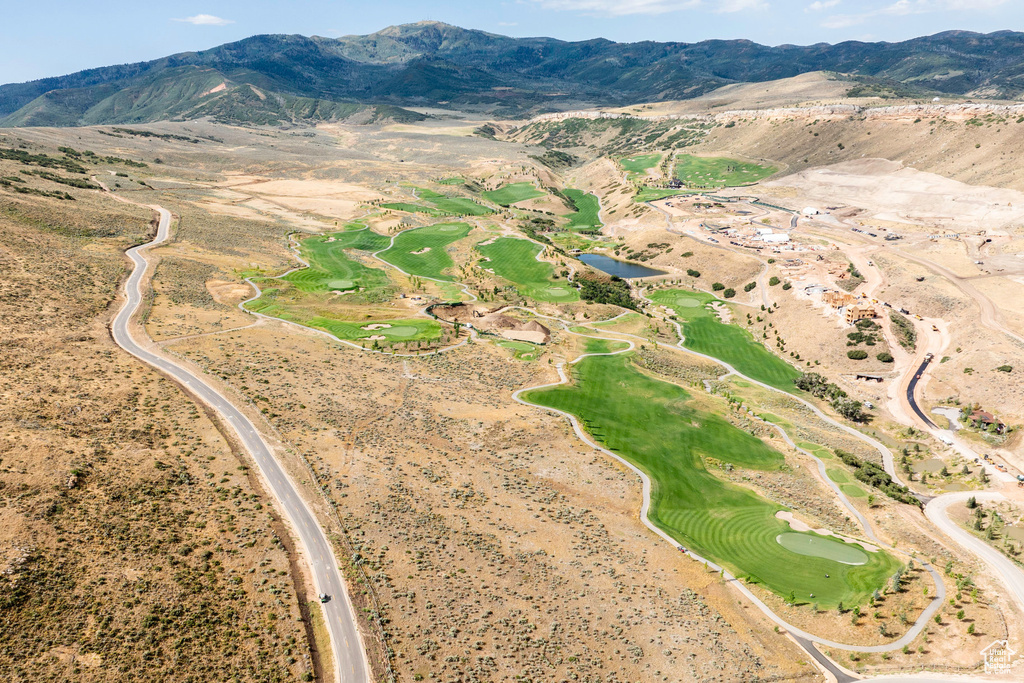 Aerial view of a mountainous background and a golf course