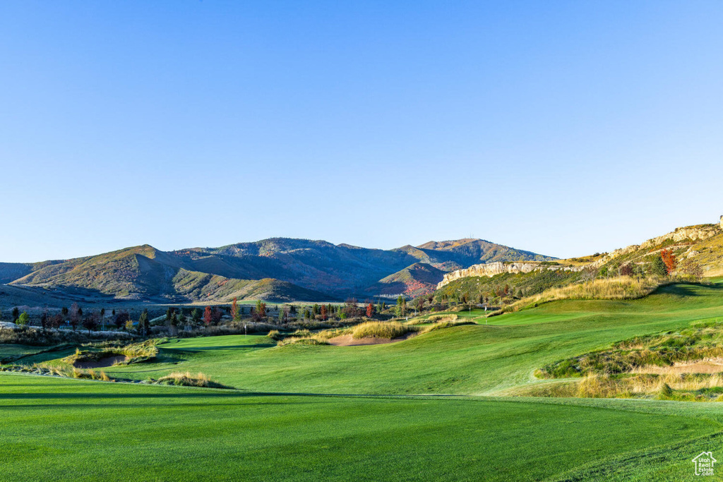 View of community with a mountain view, golf course view, and a lawn