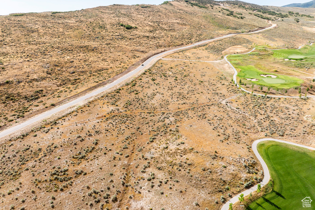 View of property location with mountains and a golf club