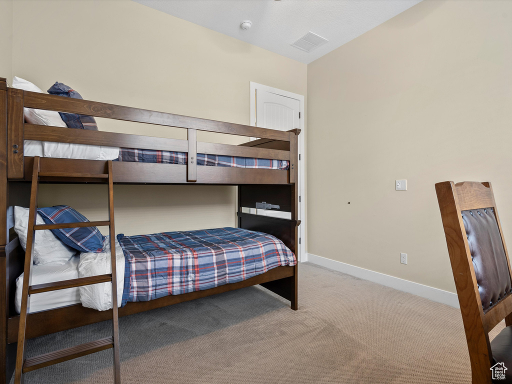 Bedroom with carpet flooring and baseboards