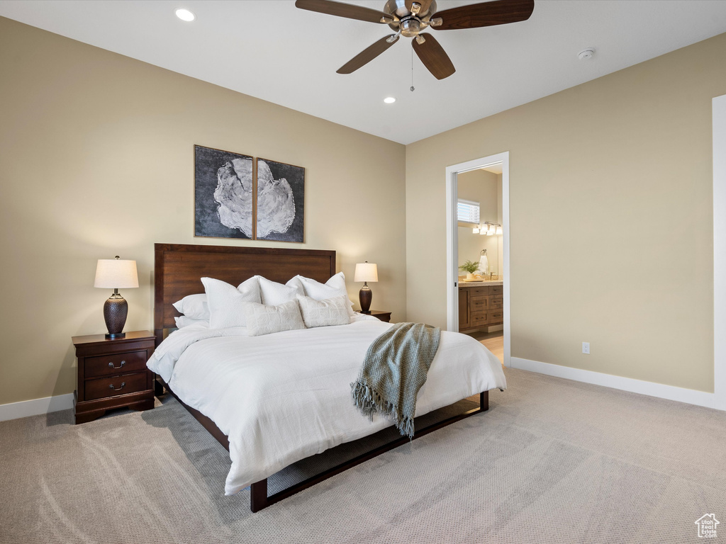 Bedroom featuring light carpet, baseboards, recessed lighting, ensuite bathroom, and ceiling fan