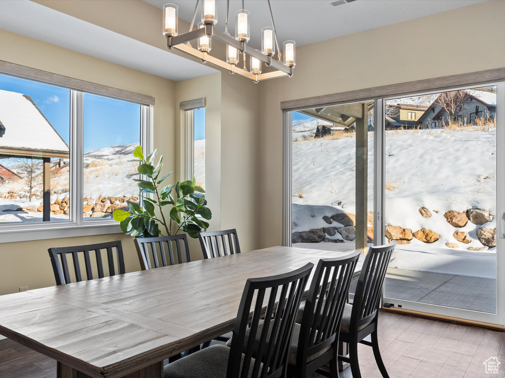 Dining room with plenty of natural light and a chandelier