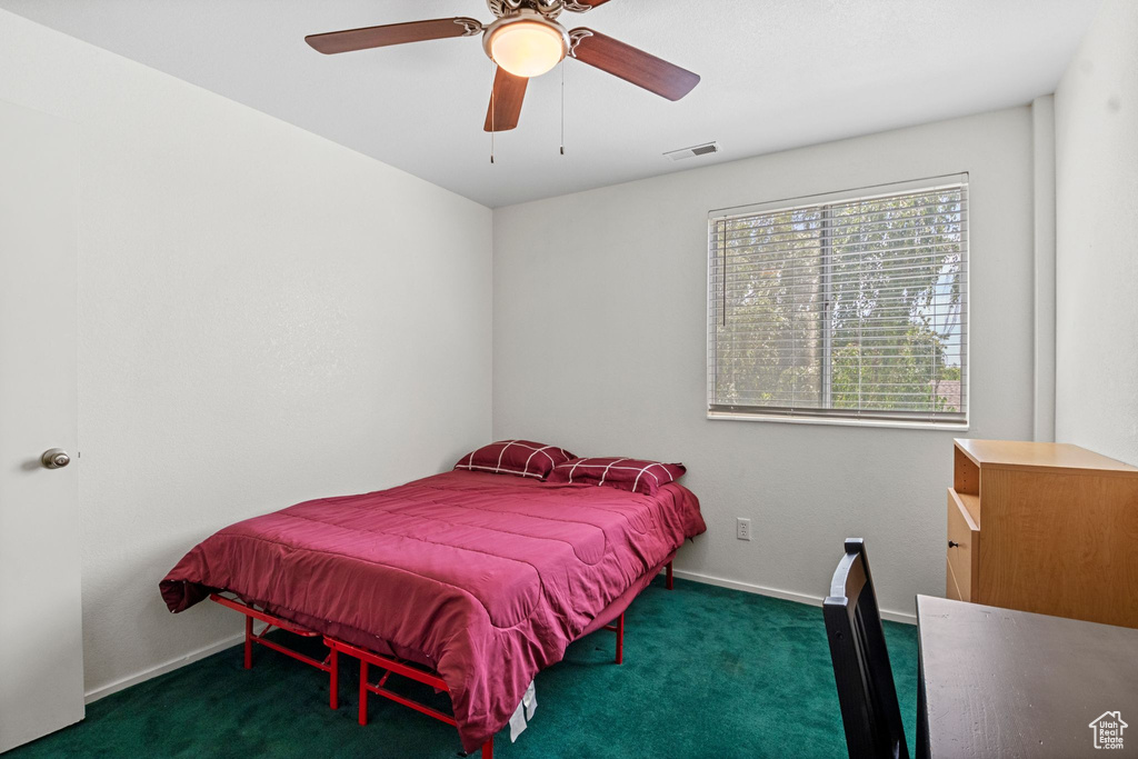 Carpeted bedroom with baseboards and ceiling fan
