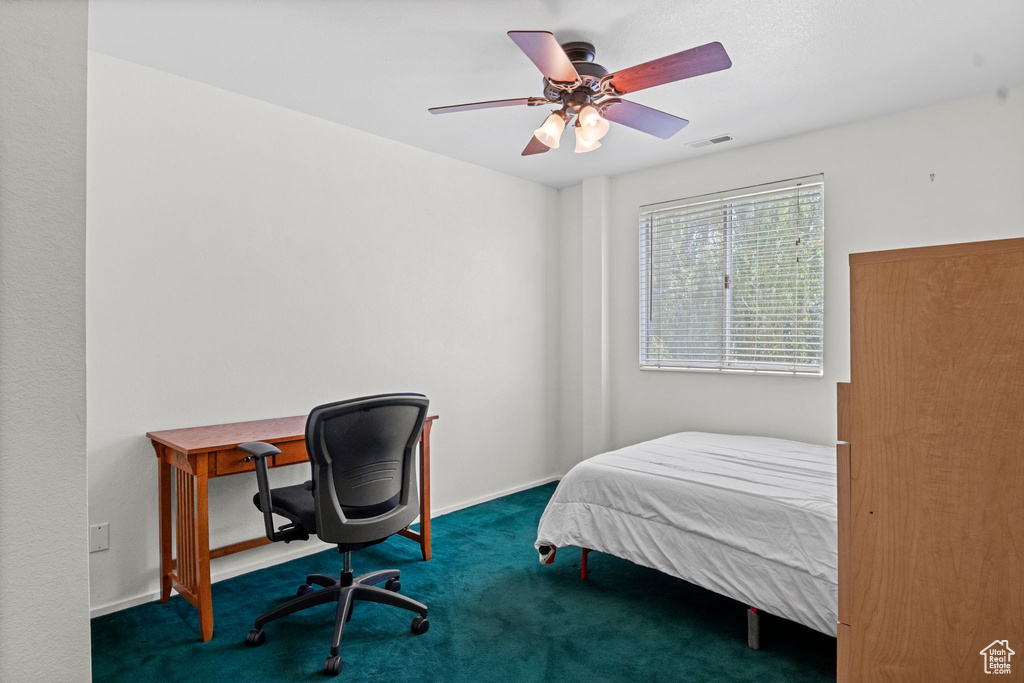Bedroom featuring carpet floors, ceiling fan, and an office area