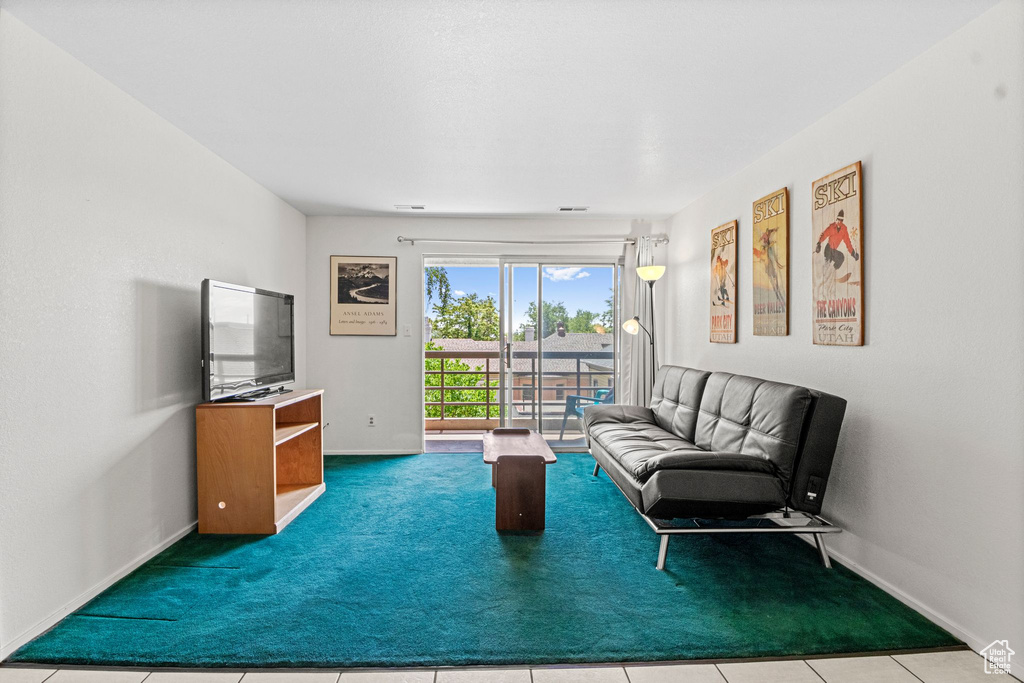 Carpeted living area with baseboards