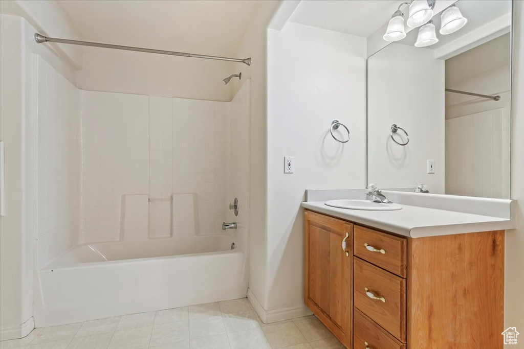 Full bath featuring bathtub / shower combination, vanity, baseboards, and tile patterned floors