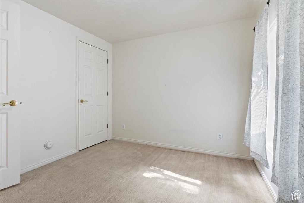 Carpeted spare room with baseboards