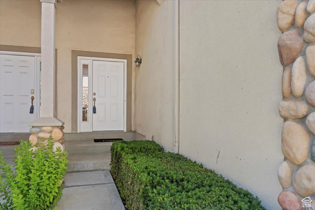 View of exterior entry with stucco siding