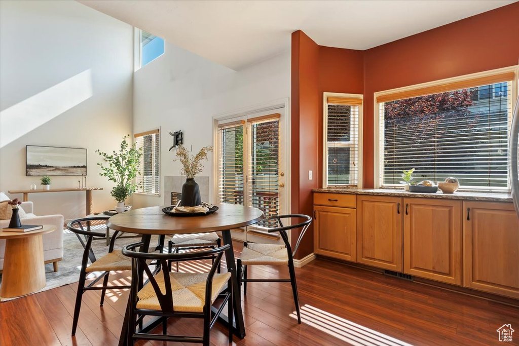 Dining space featuring dark wood-style floors and a skylight