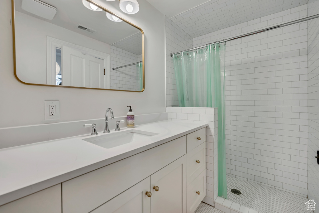 Full bathroom with a shower stall and vanity