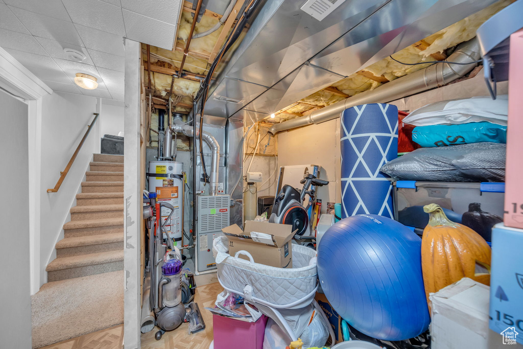 Unfinished basement with stairs and heating unit