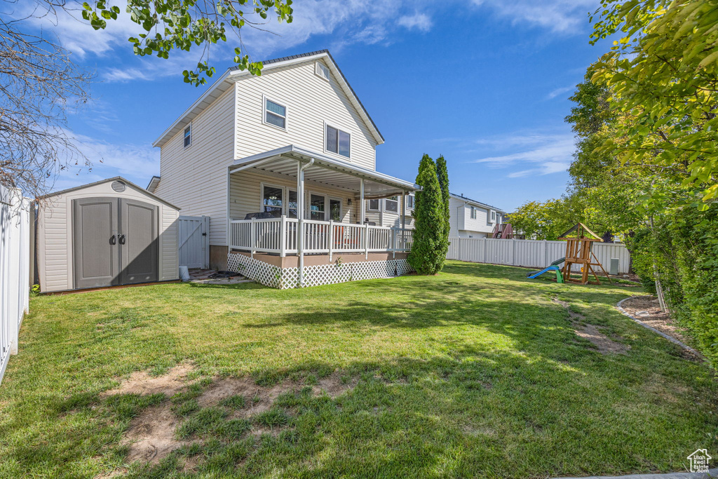 Rear view of property featuring a playground