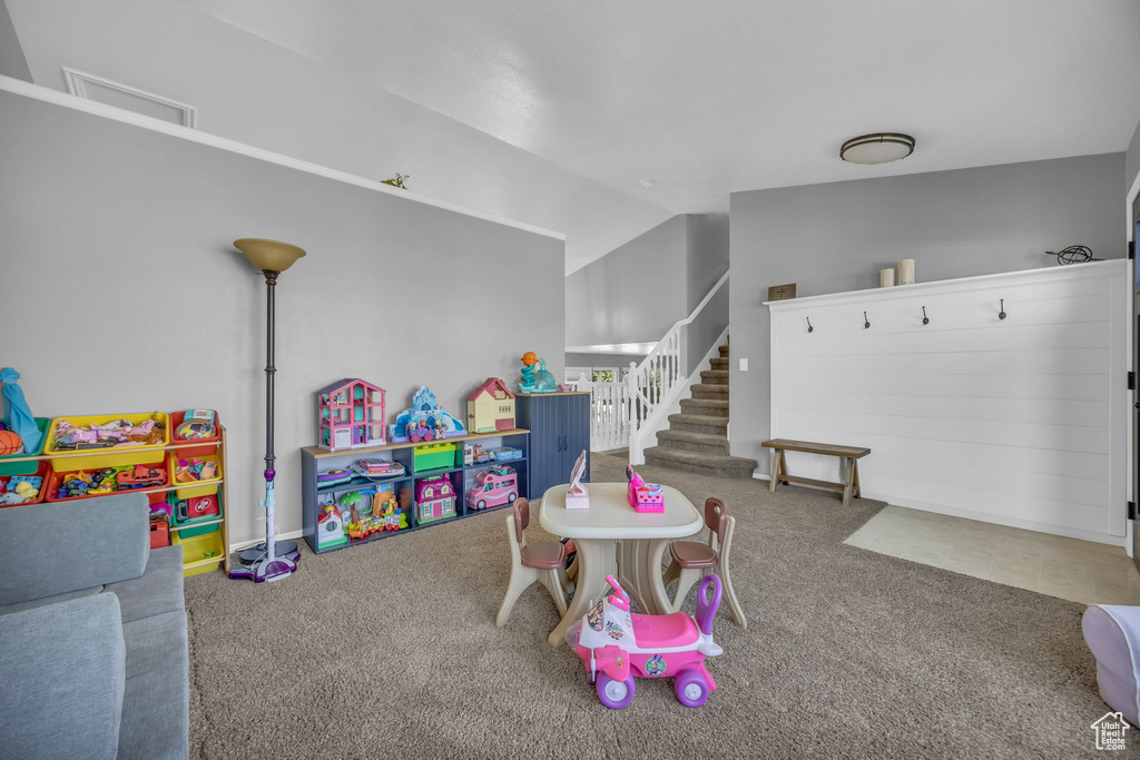 Playroom with carpet and lofted ceiling