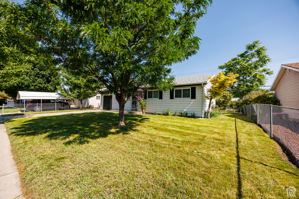 View of front of property featuring an attached garage and driveway