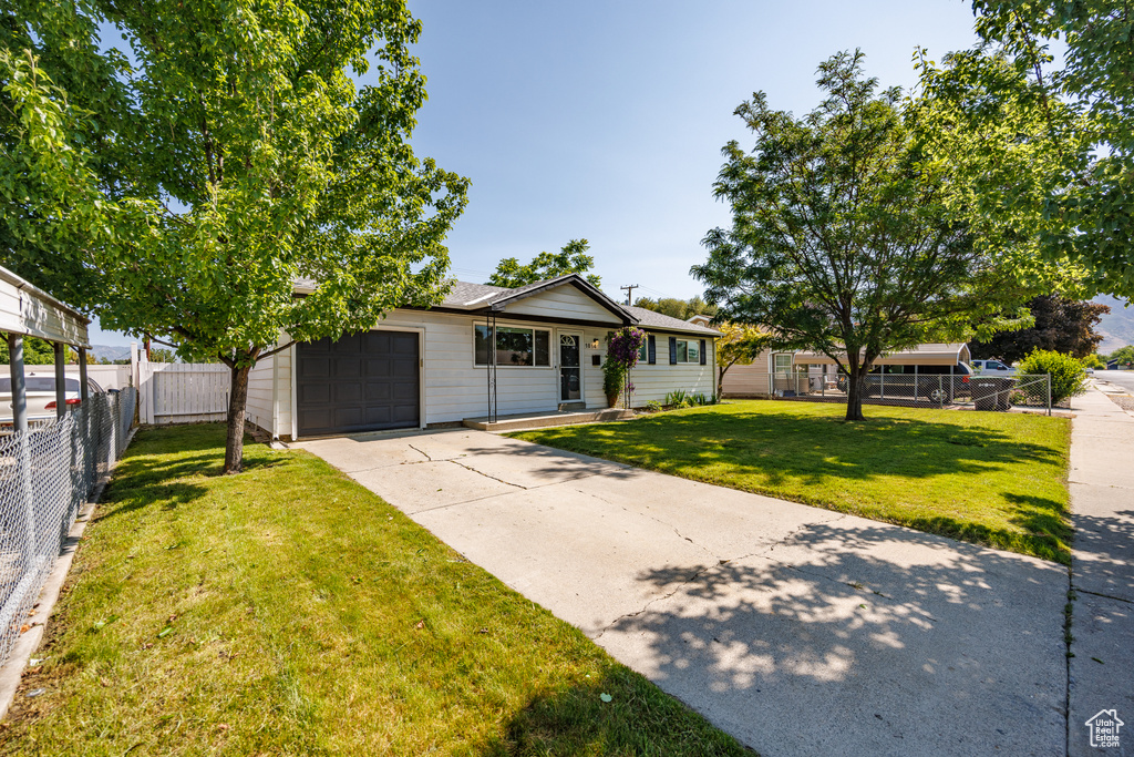 View of front of house featuring a garage and driveway
