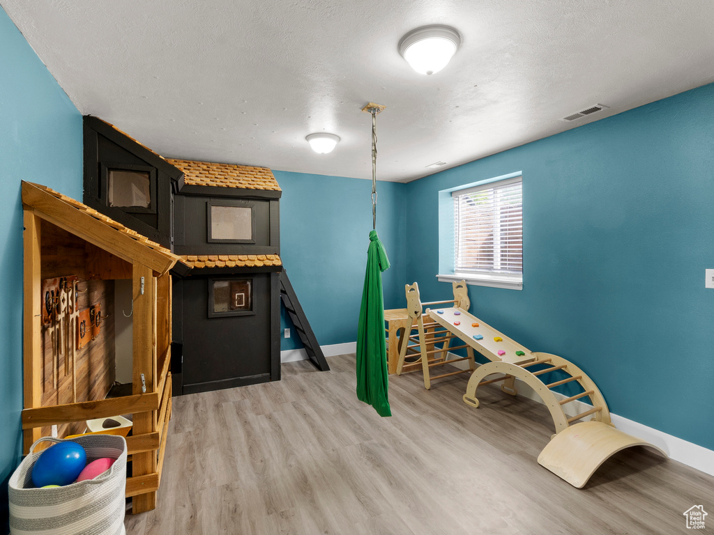 Playroom featuring wood finished floors and baseboards