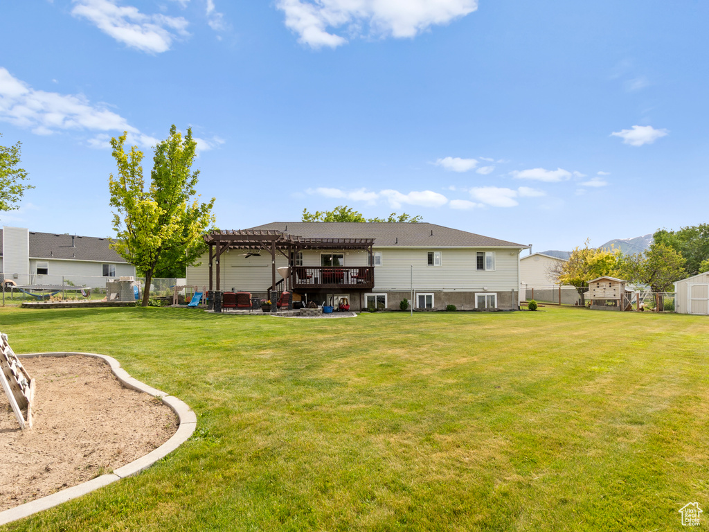 Back of property featuring a pergola and a mountain view