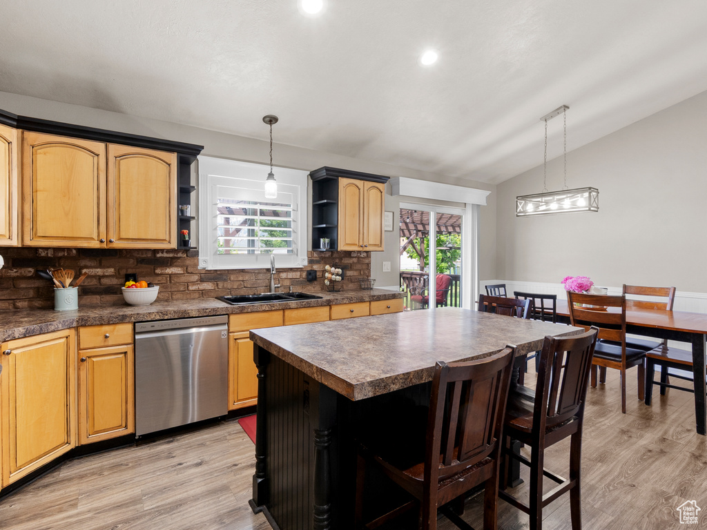 Kitchen featuring dishwasher, open shelves, a sink, lofted ceiling, and backsplash